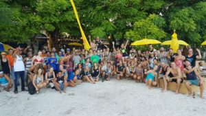 A group picture of a beach clean up, run by Gili Eco Trust, in front of Gili Divers