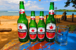 Bintang beer bottles on a beach